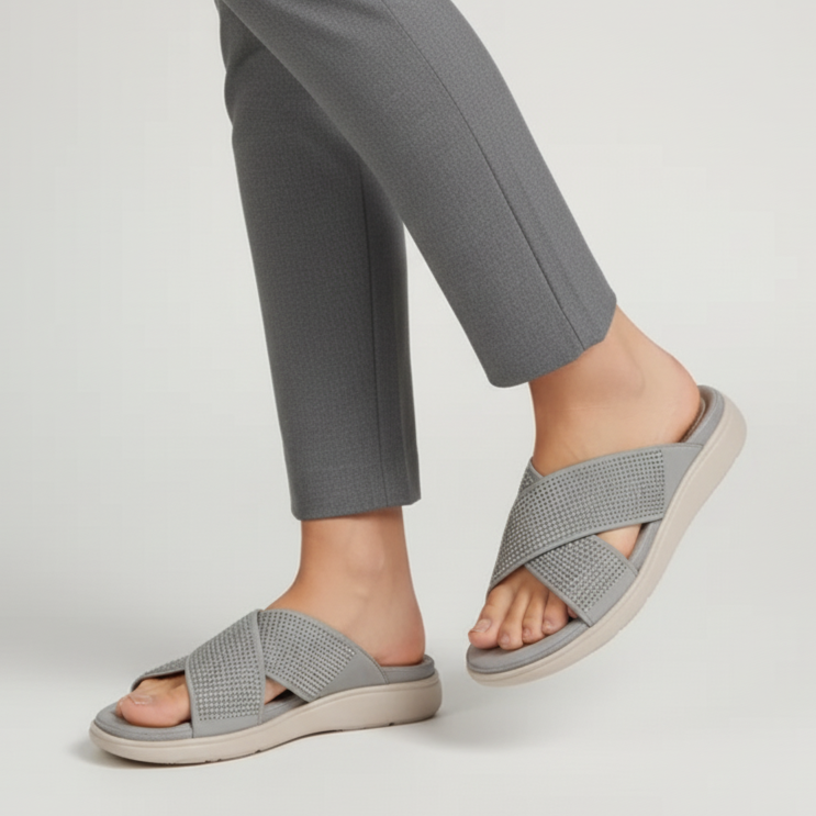 Person wearing gray checkered sandals on a light gray background