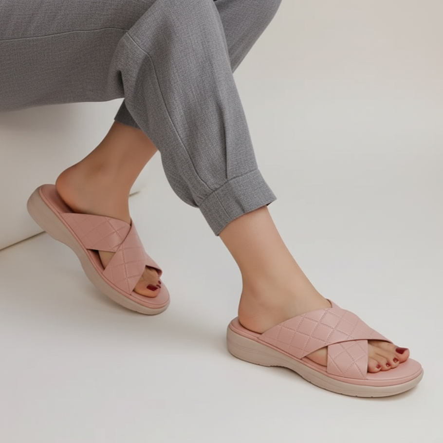 Person wearing pink sandals on a white background