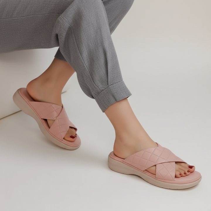 Person wearing pink sandals on a white background