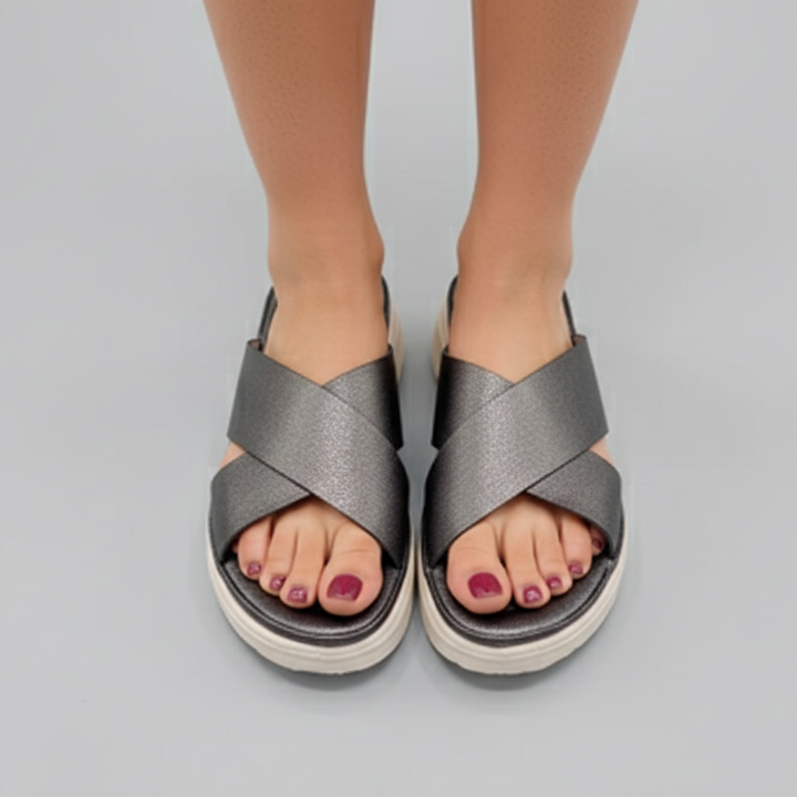 Gray sandals worn by a person on a gray background