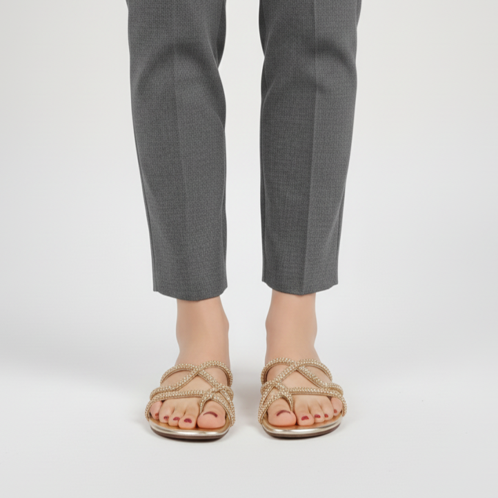 Gray pants worn by a person on a white background