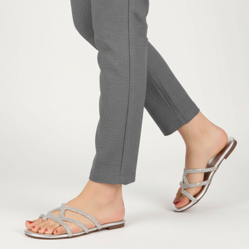 Gray pants with silver strappy sandals on a white background