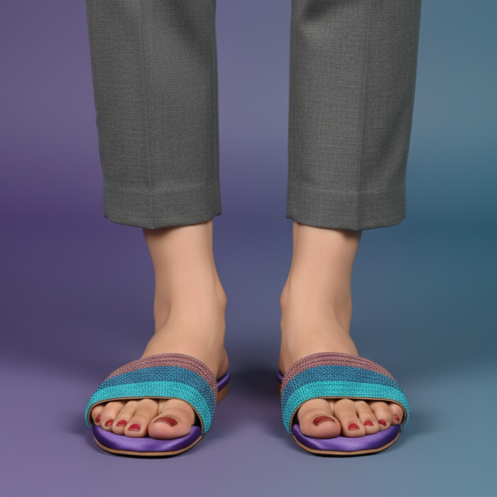 Person wearing gray pants and blue sandals on a gradient background