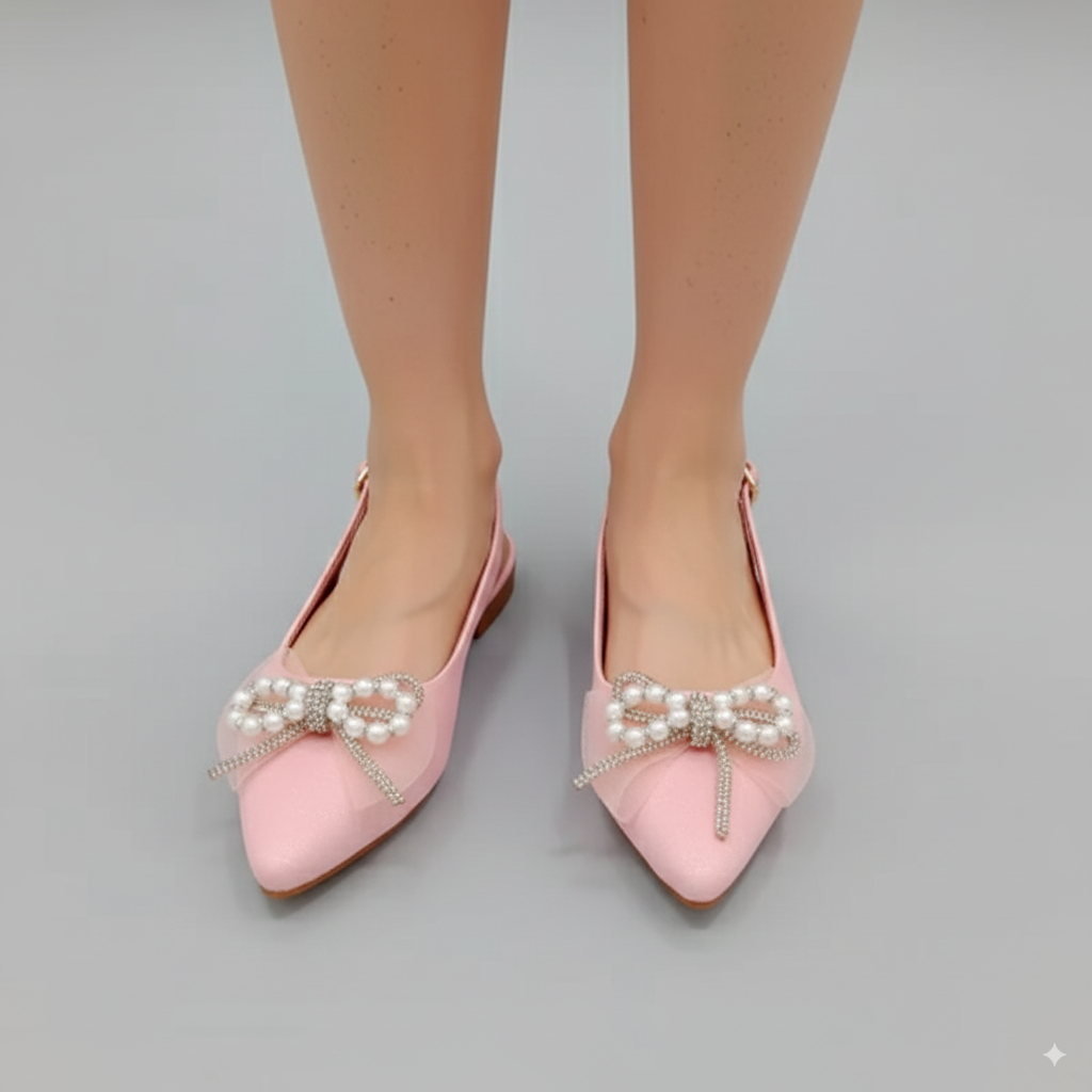 Pink pointed-toe shoes with pearl embellishments on a gray background