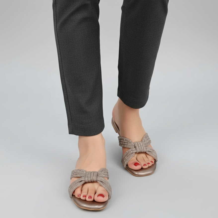 Person wearing gray sandals on a plain background
