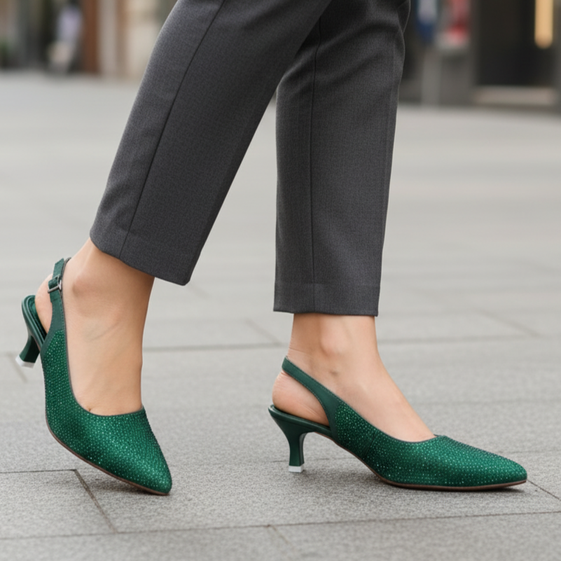Green high-heeled shoes worn with gray pants on a blurred street background