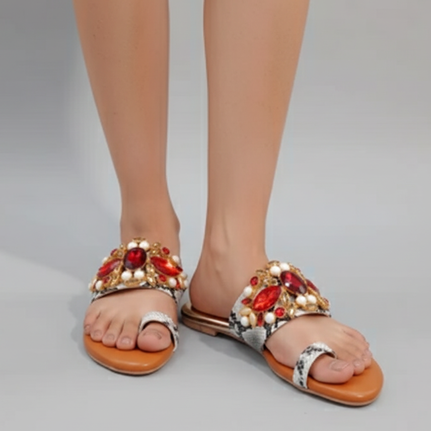 Elegant sandals with gemstone embellishments on a neutral background