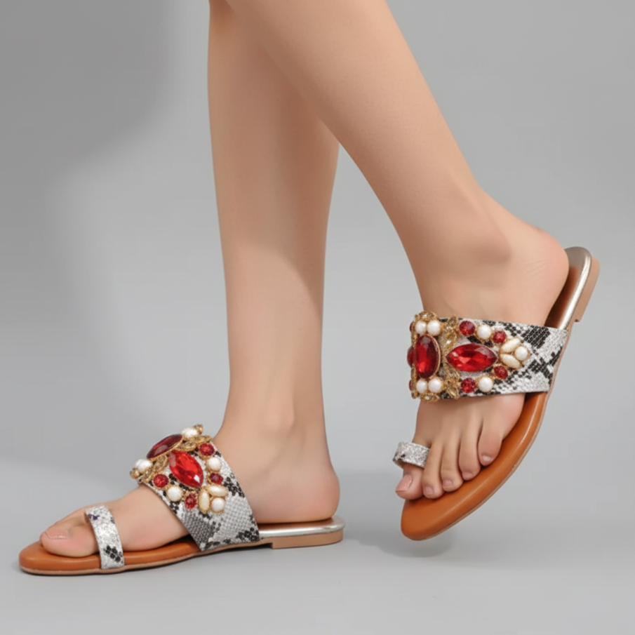 Decorative sandals with gemstones on a gray background