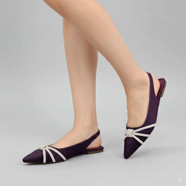 Purple shoes with white straps worn by a person on a gray background