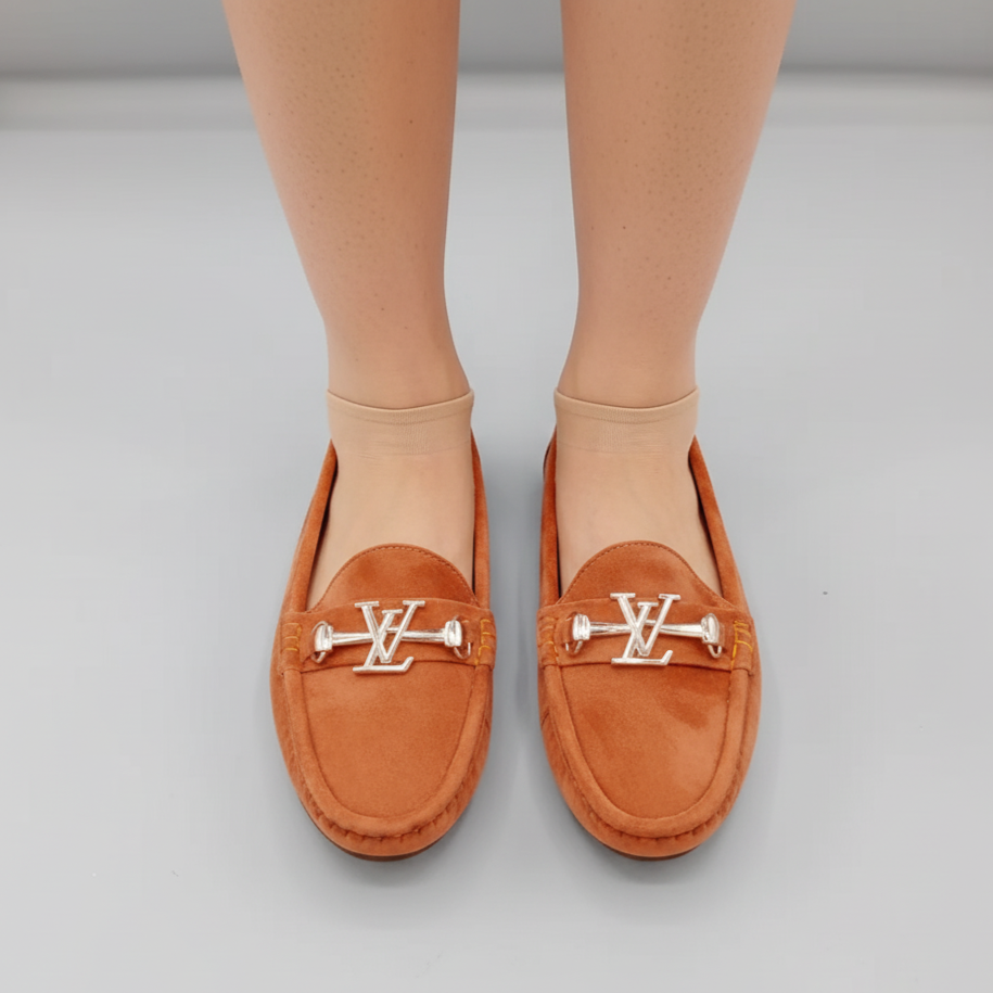 Brown loafers with a logo on a light gray background