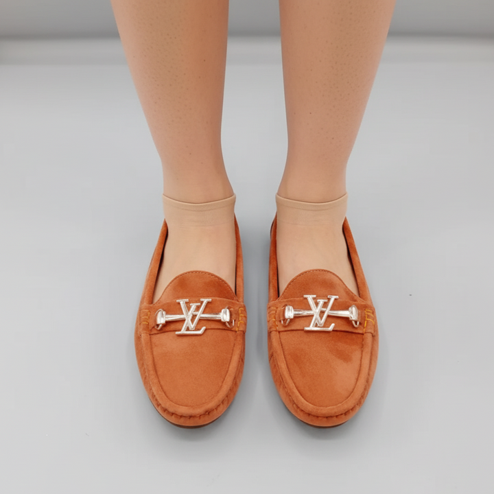 Brown loafers with a logo on a light gray background