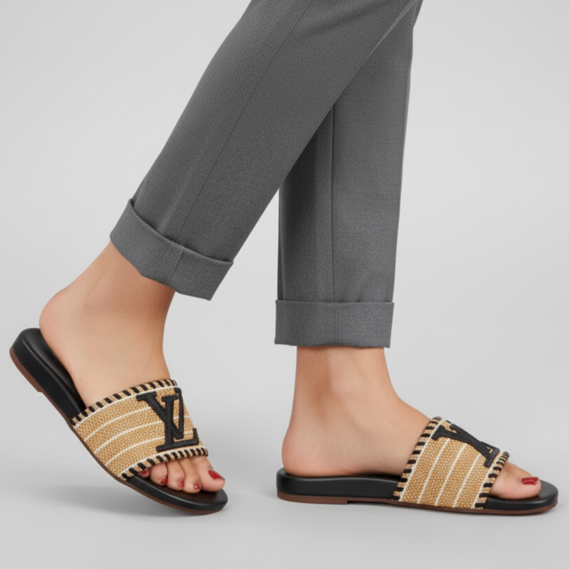 Person wearing woven sandals with a plain background