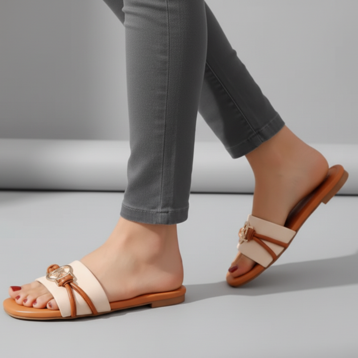 Brown sandals worn with gray pants on a light gray background