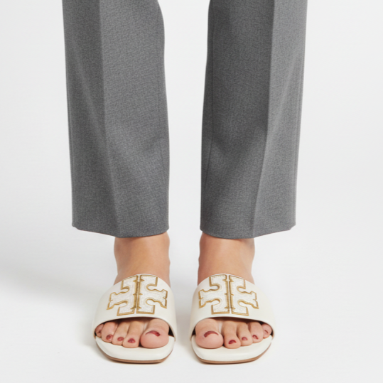 Gray pants worn by a person on a white background