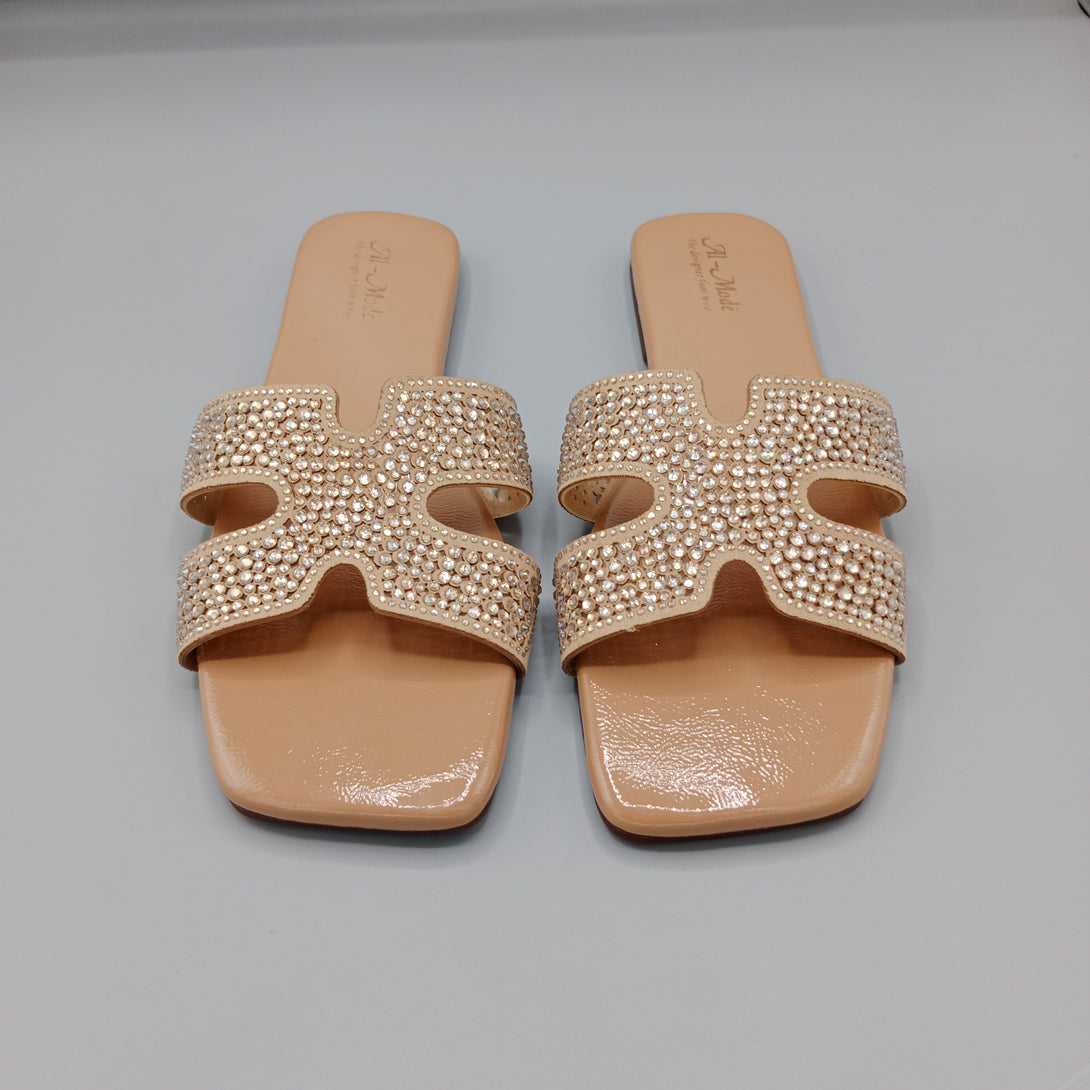 Pair of embellished sandals on a gray background