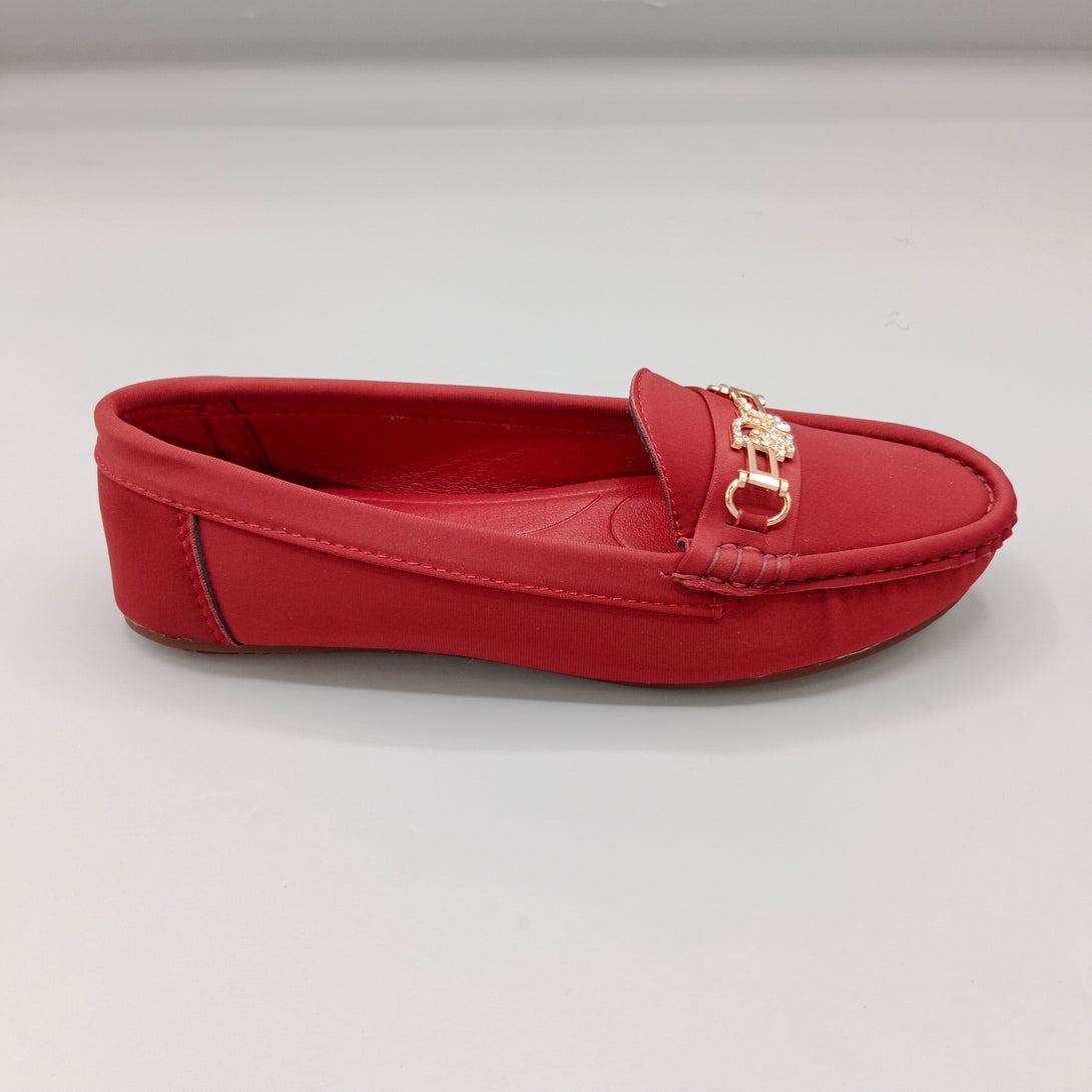 Red loafer shoe with a gold buckle on a light gray background