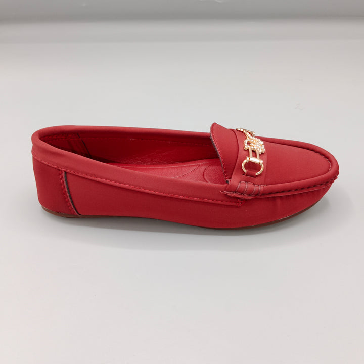 Red loafer shoe with a gold buckle on a light gray background