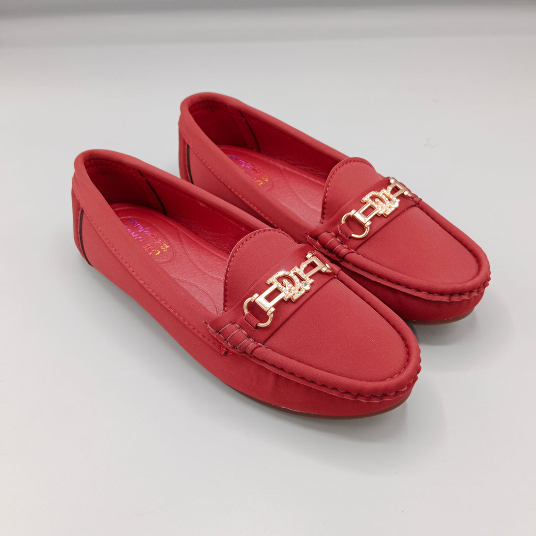 Pair of red loafers with gold accents on a light gray background