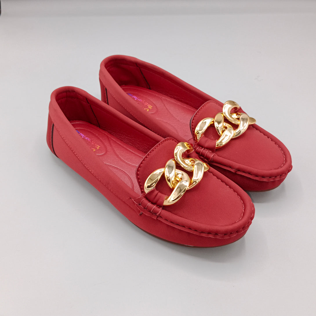Red loafers with gold chain details on a light gray background