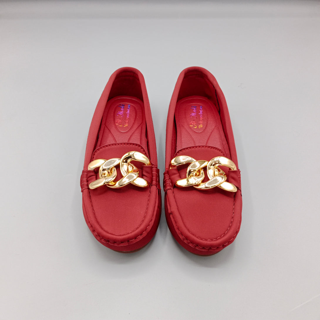 Red loafers with gold chain detail on a light gray background