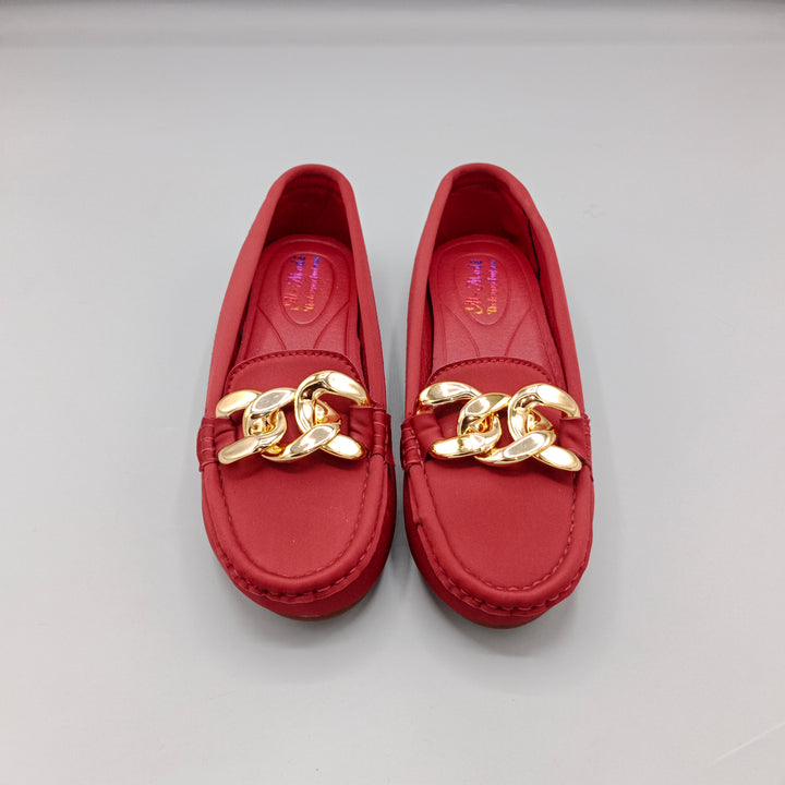 Red loafers with gold chain detail on a light gray background