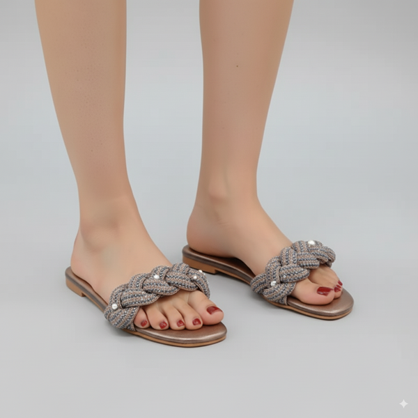 Gray braided sandals worn by a person on a light gray background